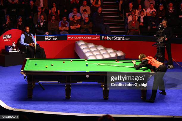 Mark Williams of England lines up a shot in his match against Rory McLeod during the PokerStar.com Masters snooker tournament at Wembley Arena on...