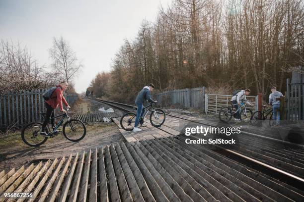 safely crossing the railroad tracks - train crossing stock pictures, royalty-free photos & images