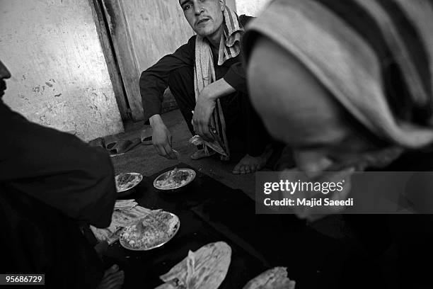 Drug addicts going through the Wadan detox program eat lunch at the Kabul Drug Treatment and Rehabilitation Center January 03, 2010 in Kabul,...