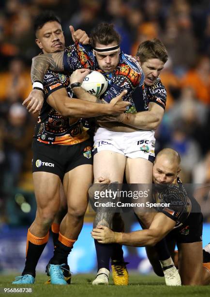 Ethan Lowe of the Cowboys is tackled during the round 10 NRL match between the Wests Tigers and the North Queensland Cowboys at Leichhardt Oval on...