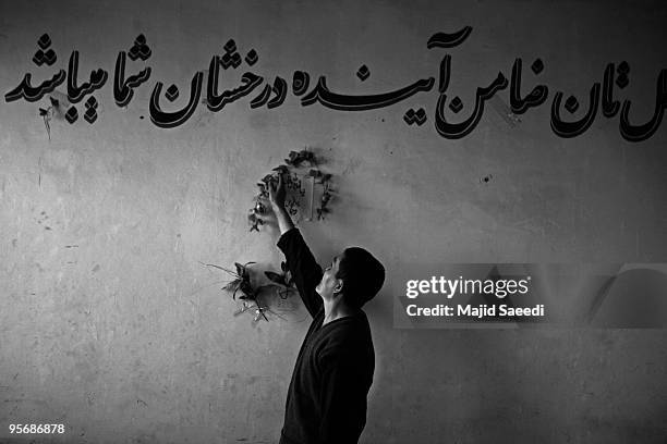 Drug addict arranges flowers on the wall at the Kabul Drug Treatment and Rehabilitation Center 03 January 2010 in Kabul, Afghanistan. An NGO & WADAN...