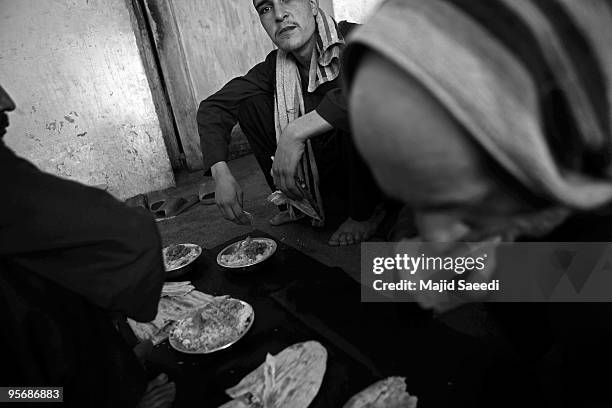 Drug addicts going through the Wadan detox program eat lunch at the Kabul Drug Treatment and Rehabilitation Center 03 January 2010 in Kabul,...