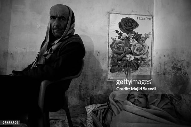 Drug addicts sit next to the heater in Wadan detox program at the Kabul Drug Treatment and Rehabilitation Center on January 03, 2010 in Kabul,...