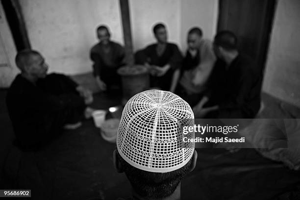 Drug addicts sit next to the heater in Wadan detox program at the Kabul Drug Treatment and Rehabilitation Center on January 03, 2010 in Kabul,...