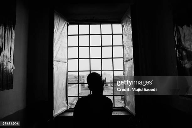 Drug addict looks out of the window while on the the Nejat detox program at the Kabul Drug Treatment and Rehabilitation Center 03 January 2010 in...