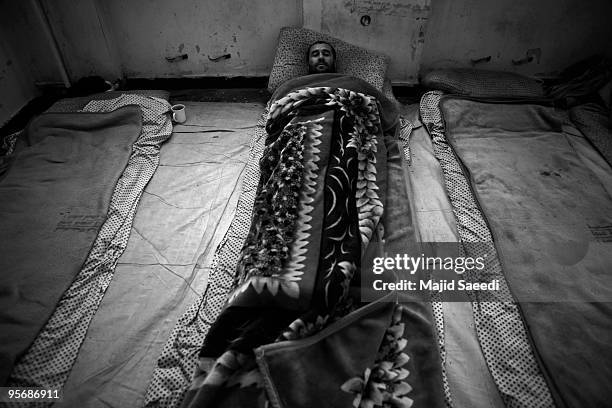 Drug addict sleeps in the sheltered area provided for the homeless at the Kabul Drug Treatment and Rehabilitation Center J03 January, 2010 in Kabul,...