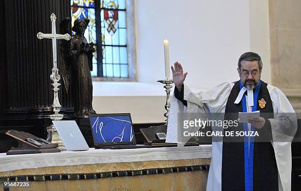 Cannon David Parrott blesses laptops, mobile phones and blackberrys during a church service at St Lawrence Jewry church, in London, on January 11,...