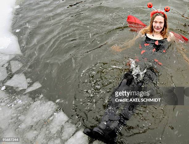 Member of a winter bathing association takes the annual bath in the frozen Orankesee lake on January 09, 2010 in Berlin. Most of the bathers stayed...