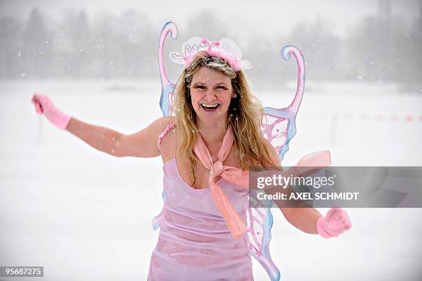 Member of a winter bathing association dressed as an angel takes the annual bath in the frozen Orankesee lake on January 09, 2010 in Berlin. Most of...