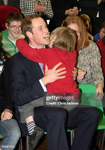 Prince William is hugged by Darren Peart as he meets children at Eresby School on January 11, 2010 in Spilsby, England. The Prince opened the Life...