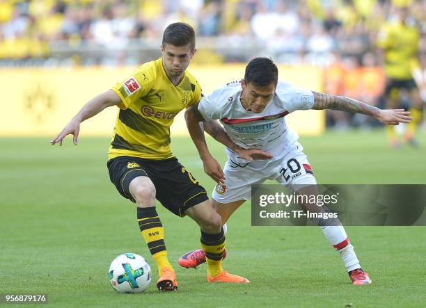 Christian Pulisic of Dortmund and Charles Aranguiz of Leverkusen battle for the ball during the Bundesliga match between Borussia Dortmund and Bayer...