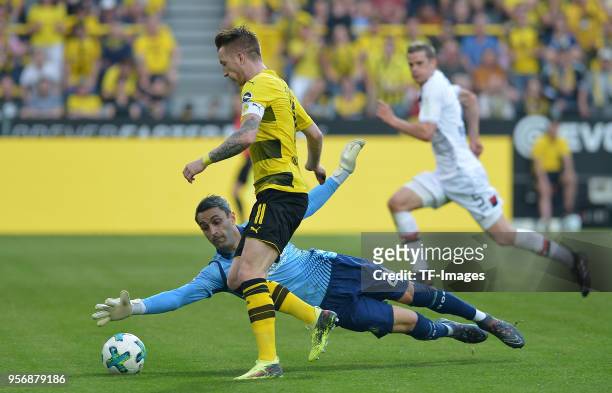 Marco Reus of Dortmund scores the team`s second goal and Goalkeeper Ramazan Oezcan of Leverkusen in action during the Bundesliga match between...