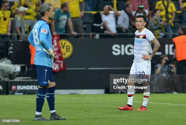 Goalkeeper Ramazan Oezcan of Leverkusen and Charles Aranguiz of Leverkusen look dejected during the Bundesliga match between Borussia Dortmund and...