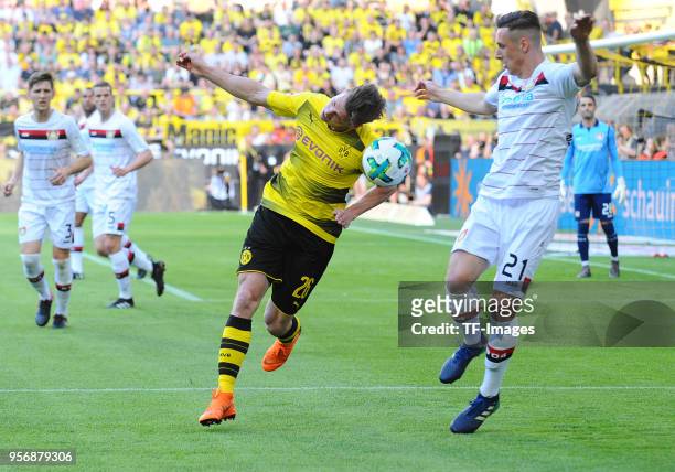 Lukasz Piszczek of Dortmund and Dominik Kohr of Leverkusen battle for the ball during the Bundesliga match between Borussia Dortmund and Bayer 04...