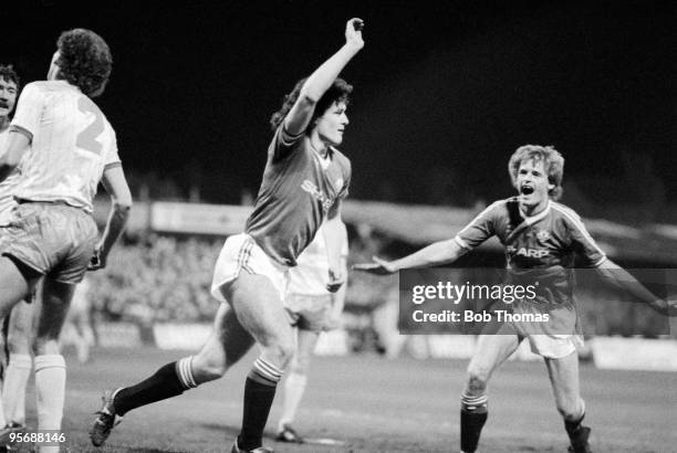 Manchester United's Mark Hughes turns to celebrate with teammate Gordon McQueen after scoring the Manchester United goal during their Football League...