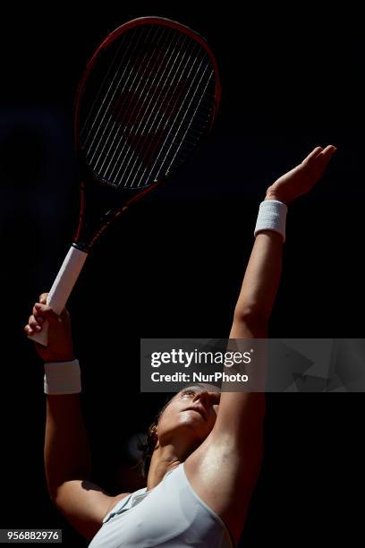 Caroline Garcia of France serves in her match against Carla Suarez Navarro of Spain during day six of the Mutua Madrid Open tennis tournament at the...