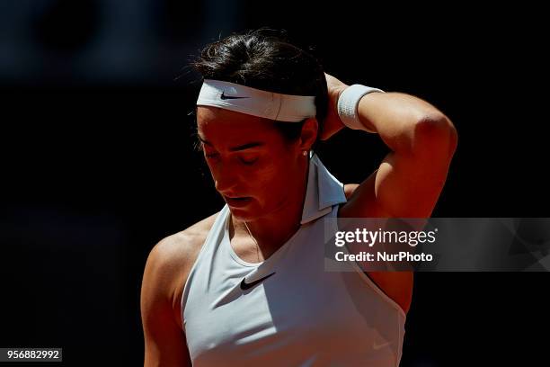 Caroline Garcia of France looks down in her match against Carla Suarez Navarro of Spain during day six of the Mutua Madrid Open tennis tournament at...