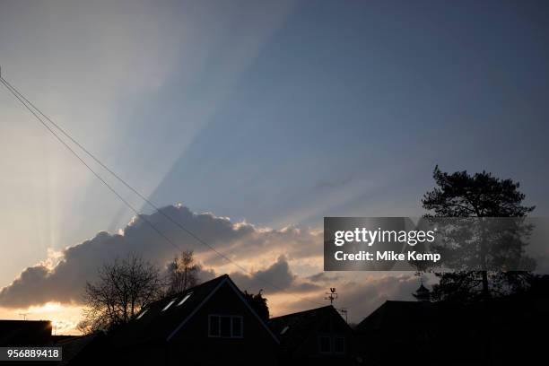 Sunlight creating a shadow in the sky from behind clouds making a dramatic evening skyscape in Henley-in-Arden, England, United Kingdom.
