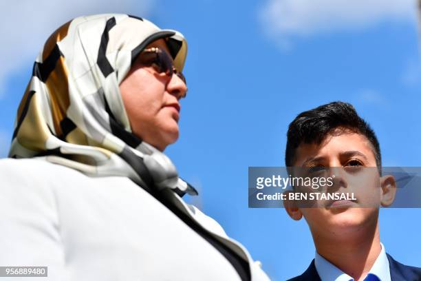 Fatima Boudchar , wife of former Islamist fighter turned politician Abdel Hakim Belhaj, and her son Abderrahim Belhaj attend a media conference on...