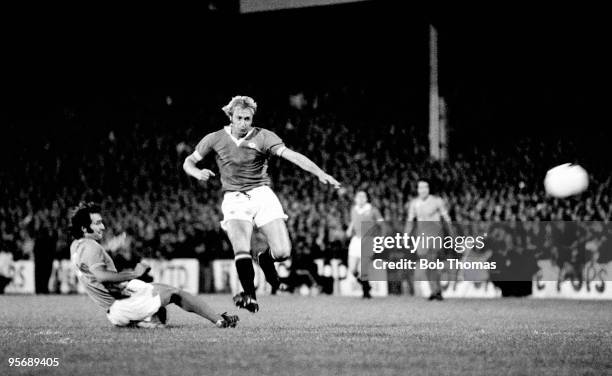 Manchester United striker Jimmy Greenhoff evades a St Etienne defender and shoots during the European Cup Winners Cup 1st round 2nd leg match played...