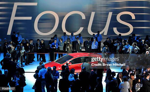 The automotive media surround the all new Ford Ford Focus after the press preview at the North American International Auto Show at the Cobo Center...