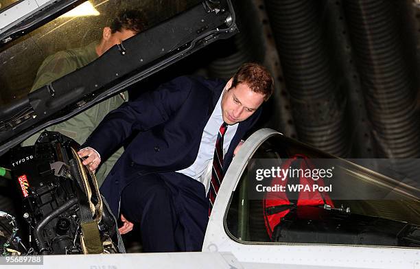 Prince William climbs into the cockpit of a Typhoon Jet during a visit to RAF Coningsby on January 11, 2010 in Lincolnshire. During his visit to RAF...