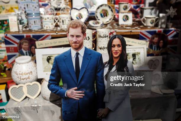Cardboard cut-outs of Prince Harry and his fiance US actress Meghan Markle sit among Royal memorabilia in a gift shop widow ahead of the couple's...
