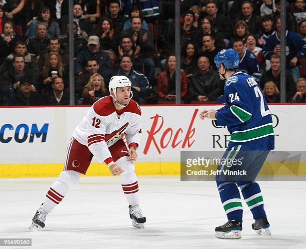 Paul Bissonnette of the Phoenix Coyotes and Darcy Hordichuk of the Vancouver Canucks square off to fight during their game at General Motors Place on...