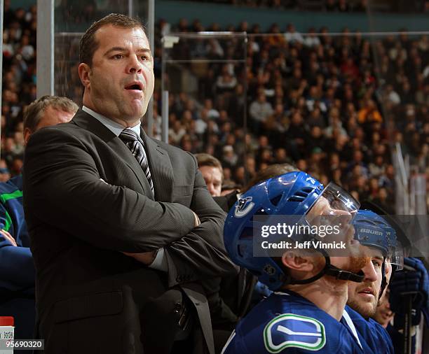 Head coach Alain Vigneault of the Vancouver Canucks looks on from the bench during their game against the Phoenix Coyotes at General Motors Place on...