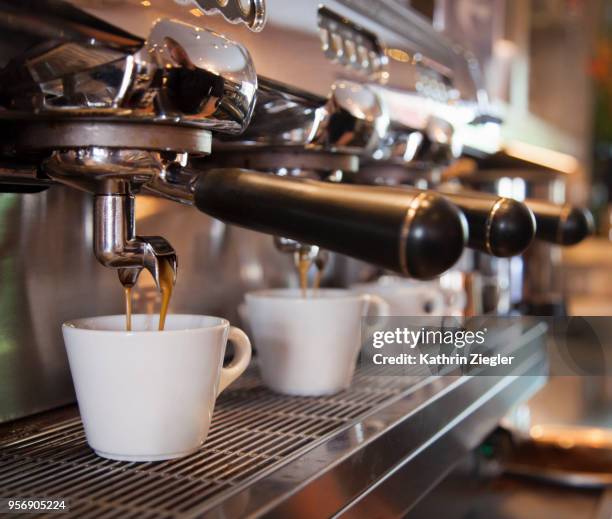 espresso machine pouring coffee into cups - coffee shop stock pictures, royalty-free photos & images