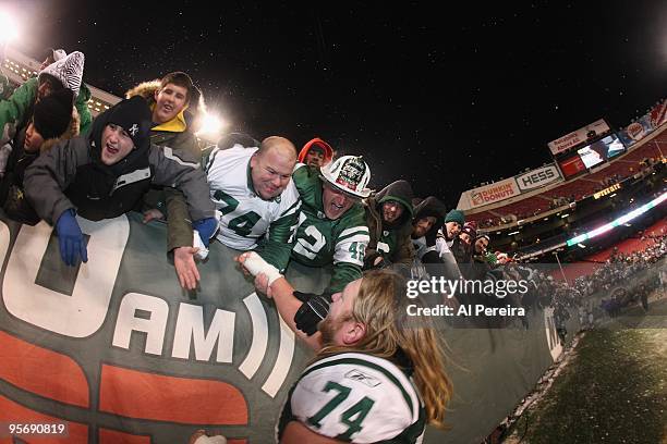 Center Nick Mangold of the New York Jets takes a "Victory Lap" to greet fans and "Fireman Ed" Anzalone after when the New York Jets host the...