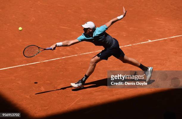 Kevin Anderson of South Africa returns a backhand to Philipp Kohlschreiber of Germany in their 3rd round match during day six of Mutua Madrid Open at...