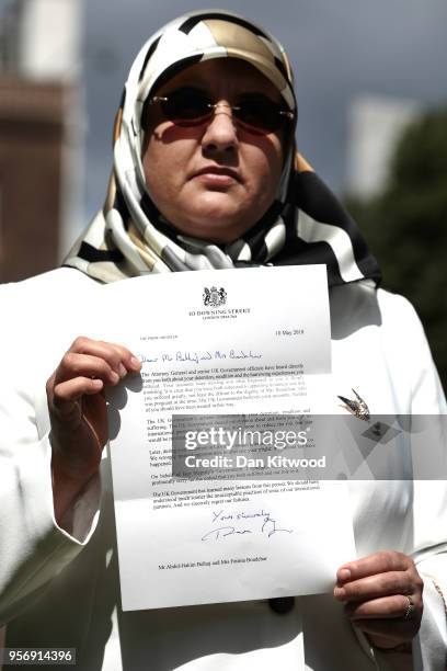 The wife of former Islamist fighter turned politician Abdel Hakim Belhaj, Fatima Boudchar, holds a letter of apology from British Prime Minister...