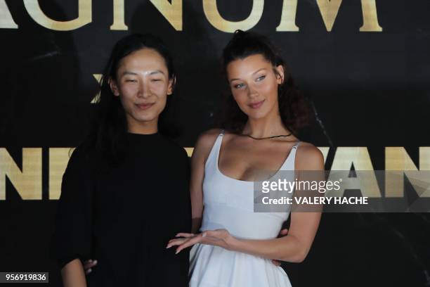 Model Bella Hadid and US fashion designer Alexander Wang pose on May 10, 2018 during a promotional event on a private beach at the 71st edition of...