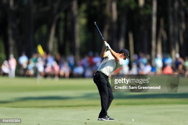 Rory McIlroy of Northern Ireland plays his second shot on the 15th hole during the first round of THE PLAYERS Championship on the Stadium Course at...