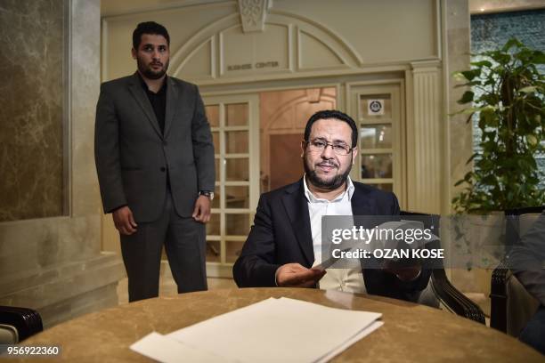 Libyan dissident Abdel Hakim Belhaj reads the letter after a press conference on May 10 after receiving a letter of apology from the UK government,...