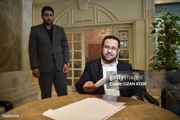 Libyan dissident Abdel Hakim Belhaj reads the letter after a press conference on May 10 after receiving a letter of apology from the UK government,...