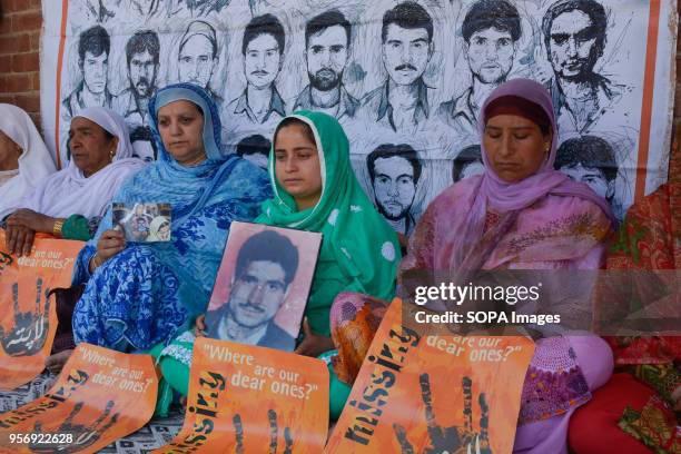 Sister of Mohammad Ramzan Sheikh holds the picture of her brother at the commemoration of her Mother Rehti Begum, an active member of APDP, who...