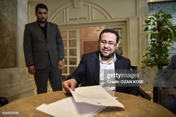 Libyan dissident Abdel Hakim Belhaj holds the letter after a press conference on May 10 after receiving a letter of apology from the UK government,...