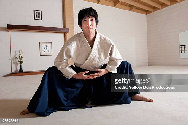 man practicing aikido martial arts - aikido stock pictures, royalty-free photos & images