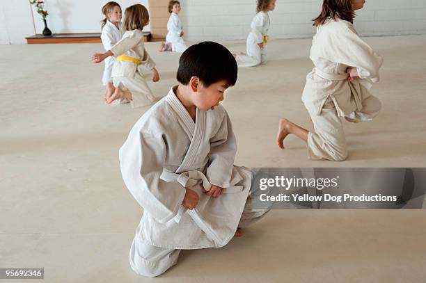 children in aikido martial arts class - bare feet kneeling girl stock pictures, royalty-free photos & images