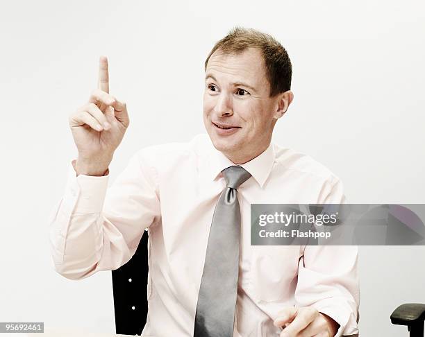 portrait of business man raising his hand - hand pointing ストックフォトと画像