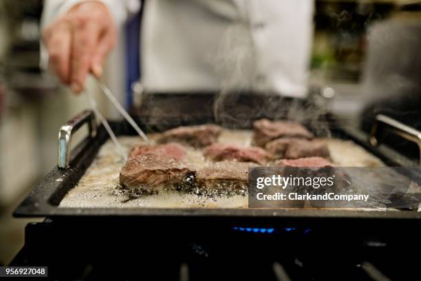 professional chef at work - griddle stock pictures, royalty-free photos & images