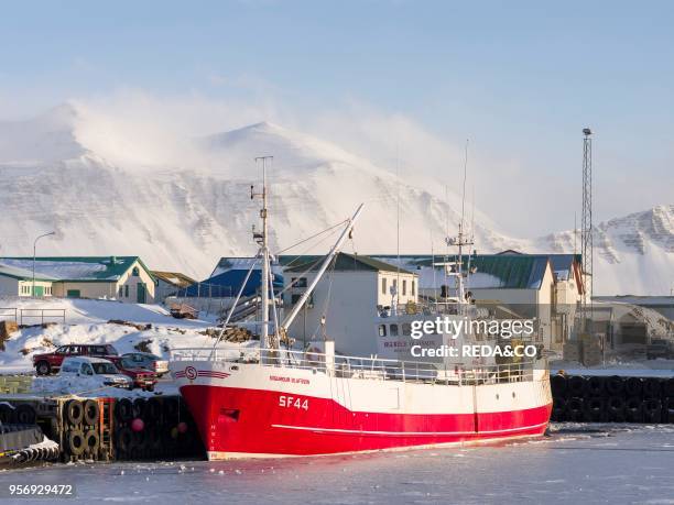 The frozen harbour of the small town Hoefn during winter. In the background the mountains of Stokksnes. Europe. Northern europe. Iceland. February.