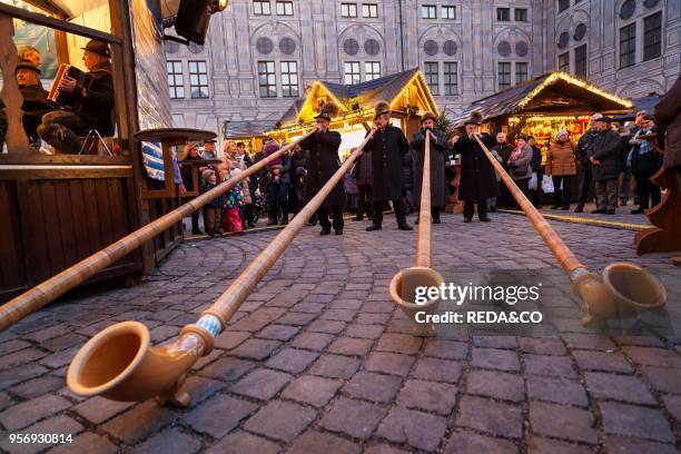 Christmas market in Munich. The alpine Christmas Village in the Kaiserhof of the Residenz. The palace of the bavarian kings. Concert with Alpenhorn ....