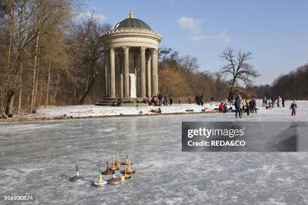 Nymphenburg Palace canals and park during winter. Badenberger See and Monopterus. Munich. Germany. It is an old tradition in Munich. That. As soon as...