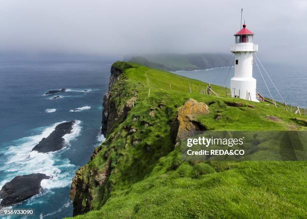 The lighthouse on Mykinesholmur. The island Mykines. Part of the Faroe Islands in the North Atlantic. Denmark. Northern Europe.