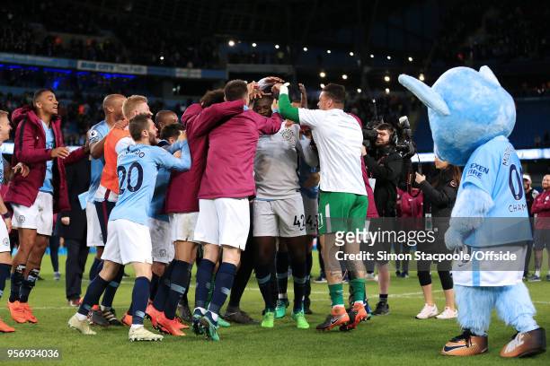 Man City players slap Yaya Toure of Man City on the head as they congratulate him after his final game for the club at the end of the Premier League...