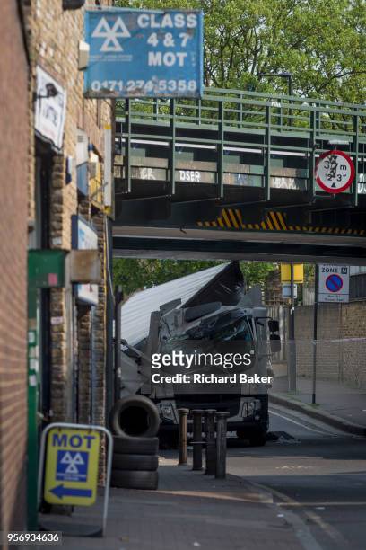 The damaged remains of a lorry near a scrap metal yard at Loughborough Junction after it crashed into one of the railway bridges - a main transport...
