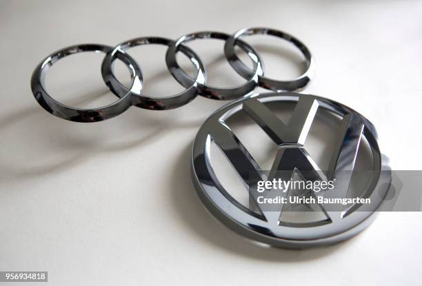 Symbol photo on the subject of manipulation at Audi and Volkswagen diesel engines. The picture shows the Audi and the Volkswsagen logo.